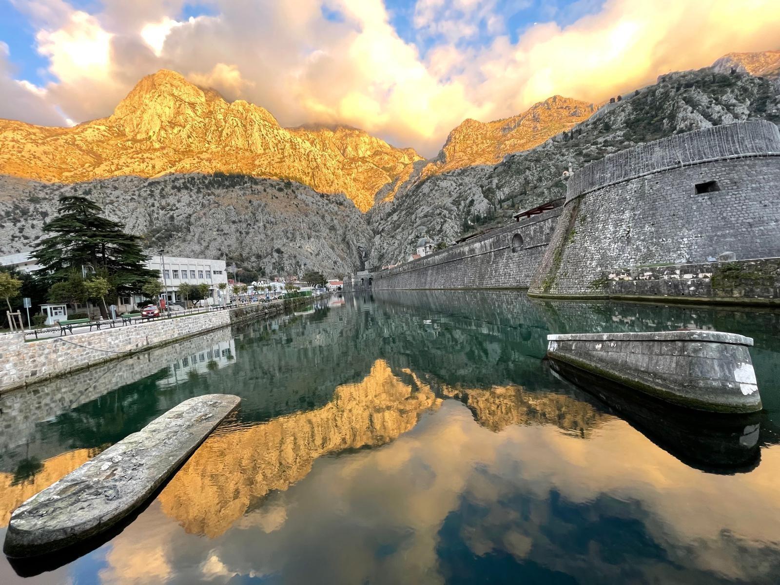 Kotor fortress walls reflected at golden hour