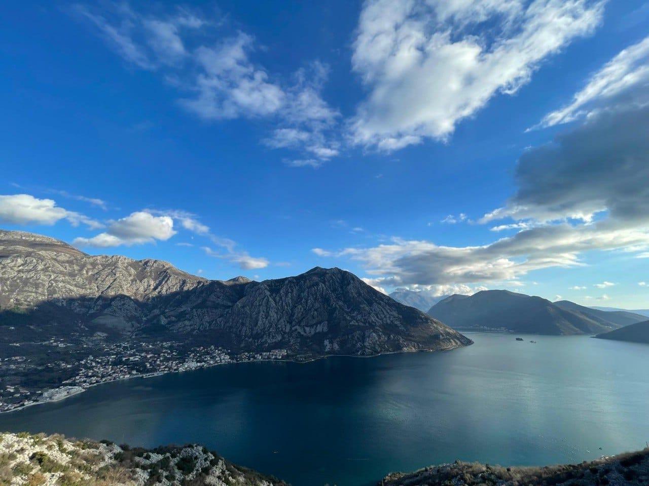 Seated on old stone ruins overlooking Kotor Bay